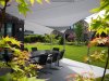 Kombination aus 2 hellen Sonnensegeln über der umlaufenden Terasse eines Einfamilienhauses | Lisori Sonnensegel