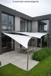 Kombination aus 2 hellen Sonnensegeln über der umlaufenden Terrasse eines Einfamilienhauses welche einen innenhofähnlichen Charakter verleihen | Lisori Sonnensegel